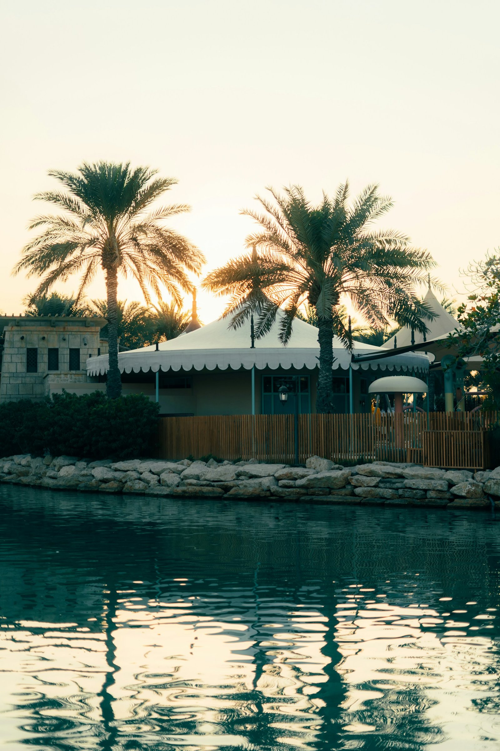 Low-rise Dubai residential architecture among palms at sunset, Madinat Jumeirah