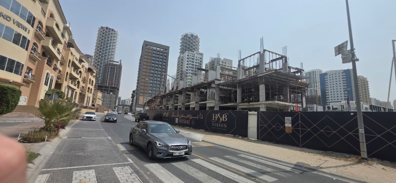 Street view of construction hoarding at The Promise Villas
