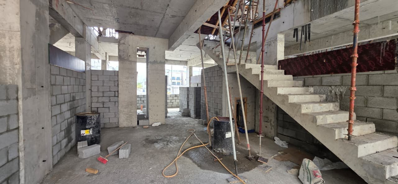 Interior structural progress showing staircase and blockwork, The Promise Villas